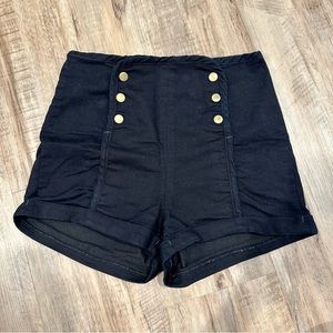 Black sailor shorts with gold snap buttons